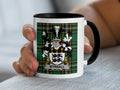 Mug with black rim and handle, displaying a tartan pattern and a crest with the name WYRRALL.