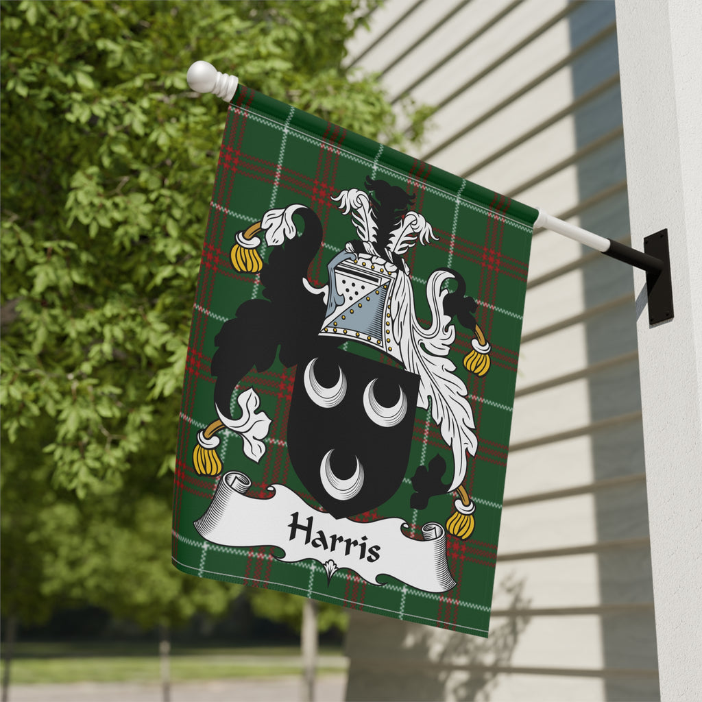 Green plaid flag with Harris family crest displayed on a white building.