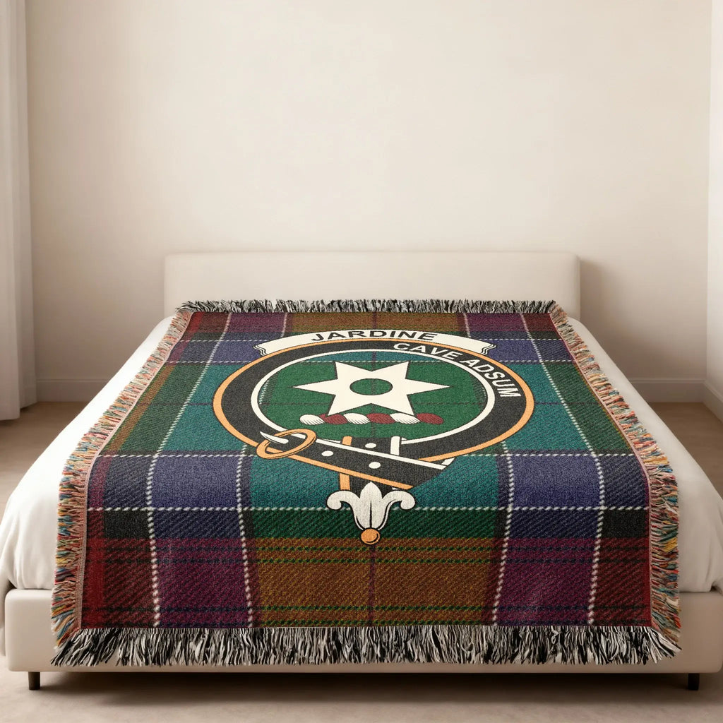 Clan Jardine tartan woven blanket — folded view showing fringe detail and Cave Adsum crest