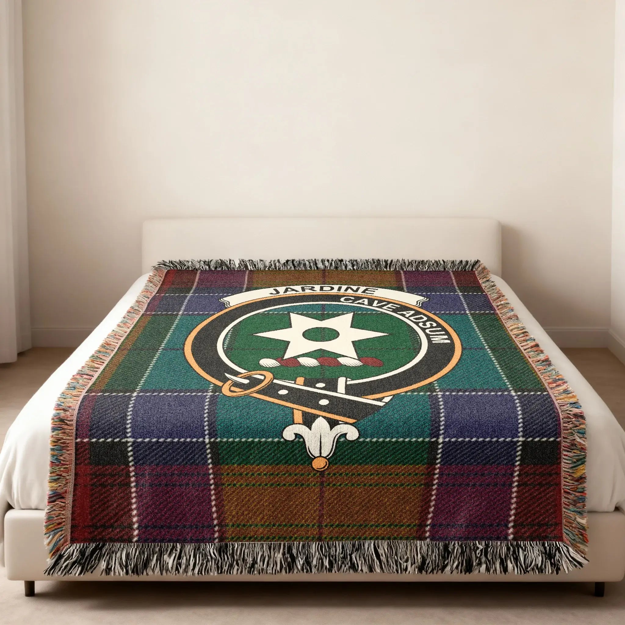Clan Jardine tartan woven blanket — folded view showing fringe detail and Cave Adsum crest