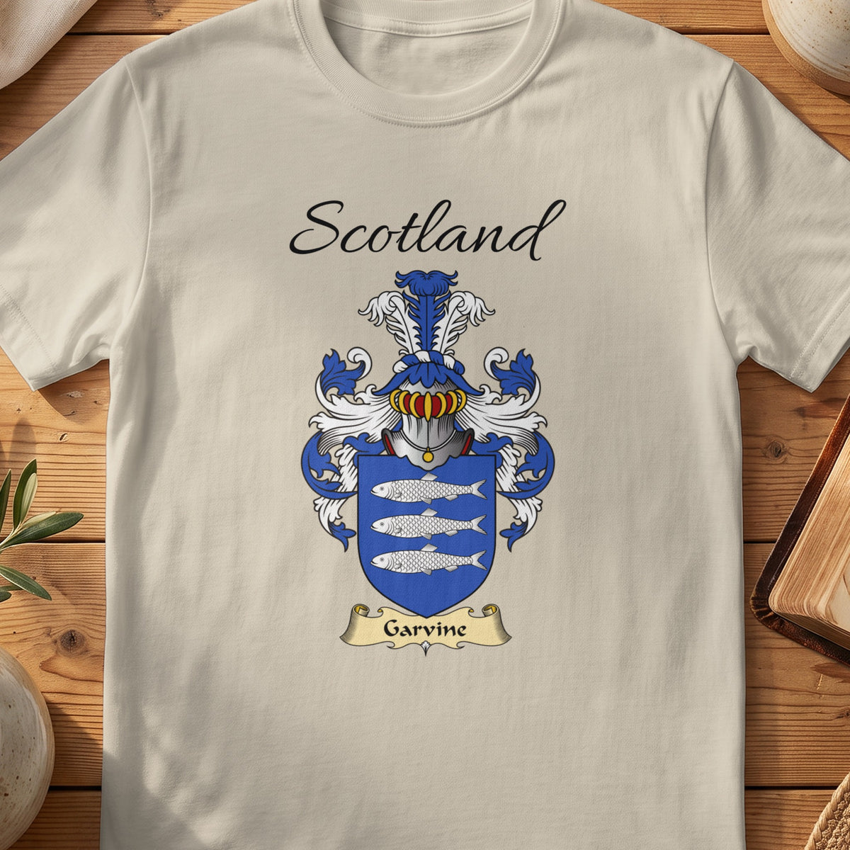 Sand Garvine Scottish family shield T-shirt featuring three silver-coloured fish on blue