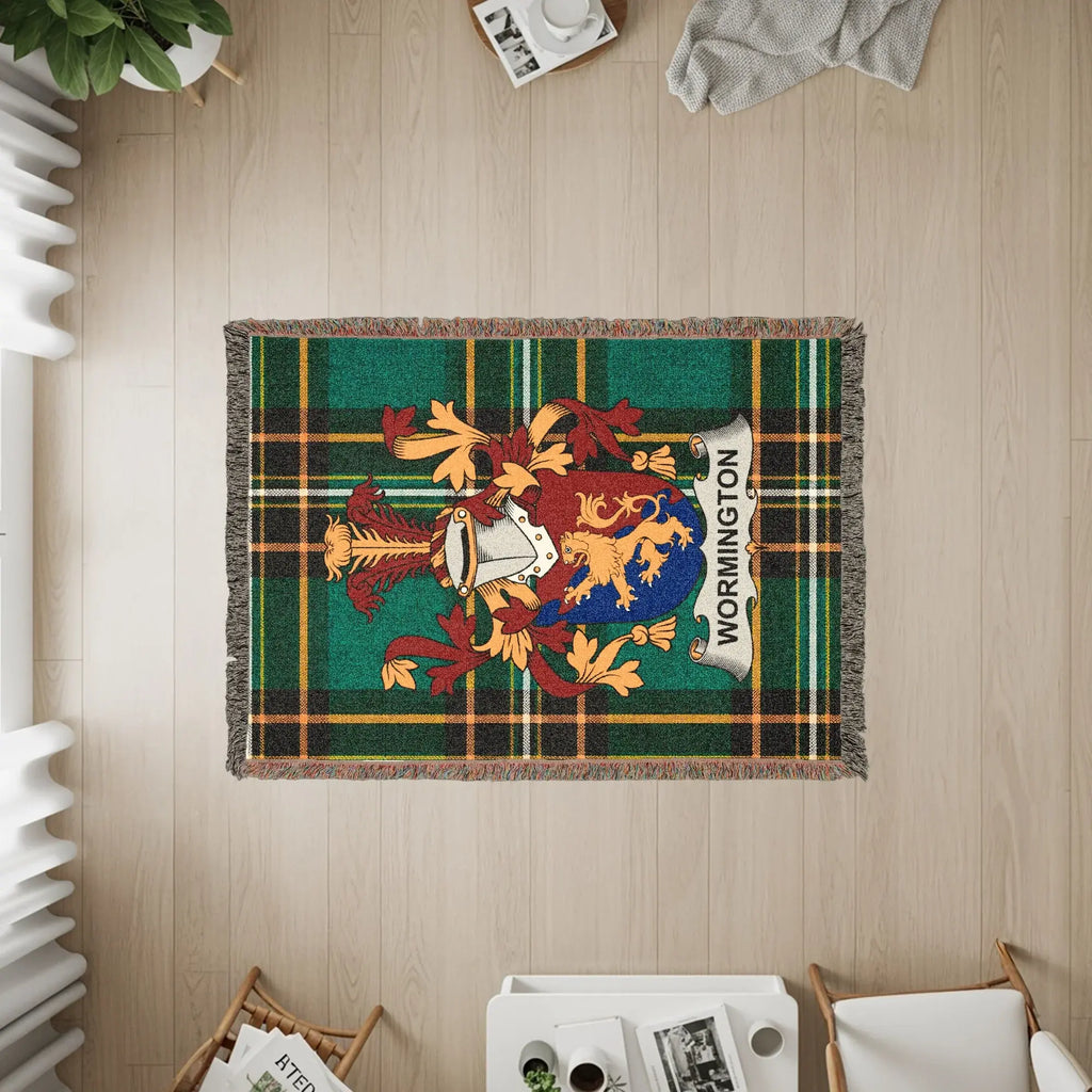Wormington tartan crest throw blanket on wooden floor with furniture.