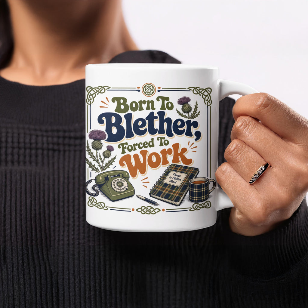 Mug with "Born to Blether, Forced to Work" text, thistle design, and notebook.