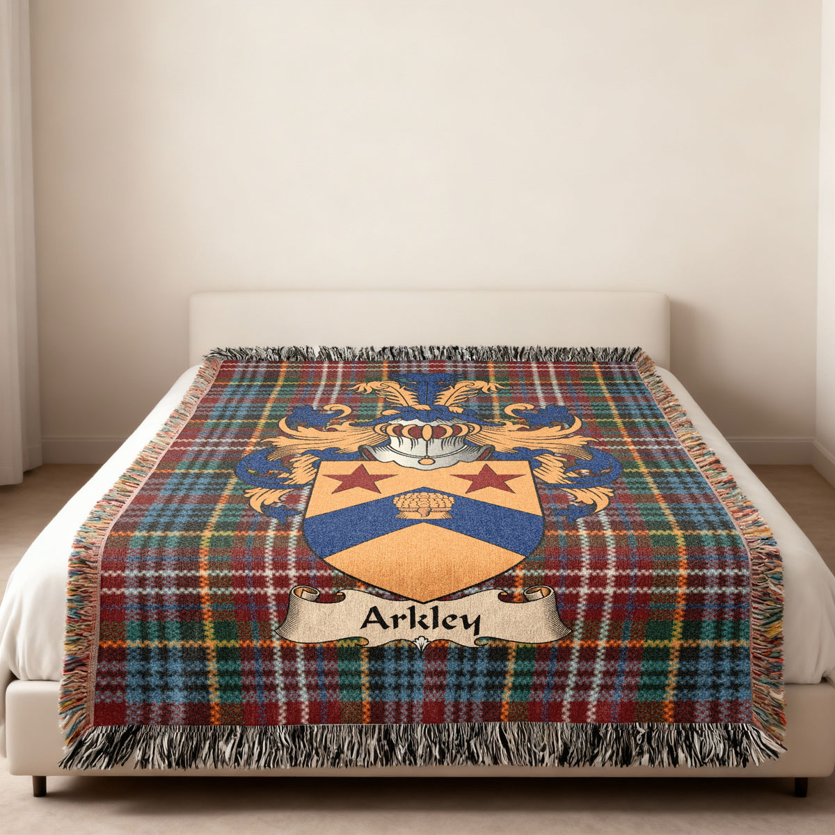 Arkley family crest emblem on a Caledonia tartan woven blanket