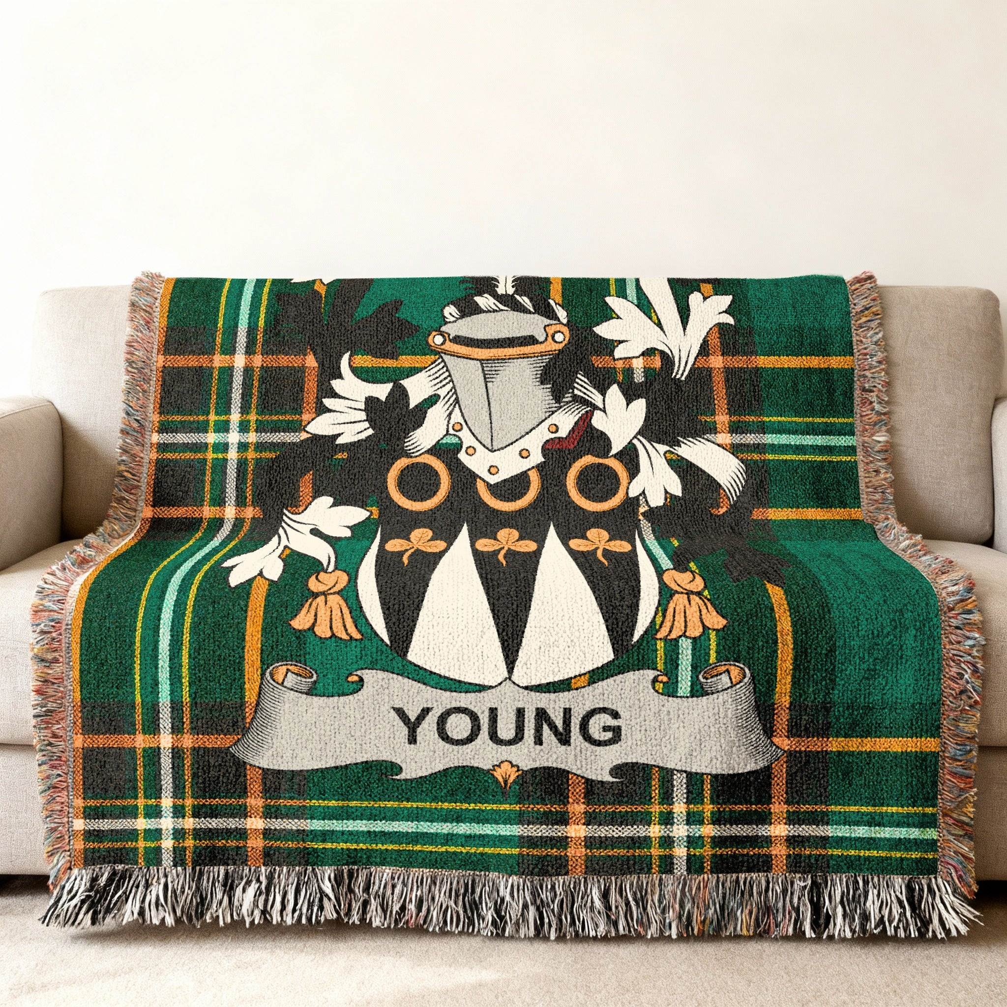 Green plaid woven blanket with the YOUNG family crest.