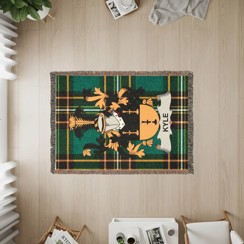 Woven blanket featuring the Kyle family crest on a plaid background.
