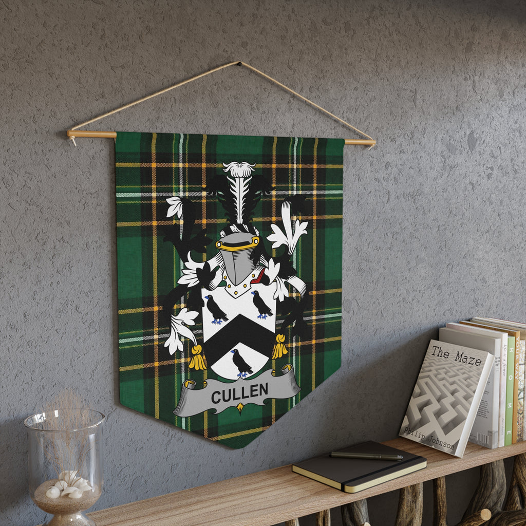 Cullen family crest banner with green plaid background, hanging on wall.