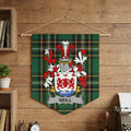 Neill family crest displayed on a green plaid banner hanging on a wooden wall.