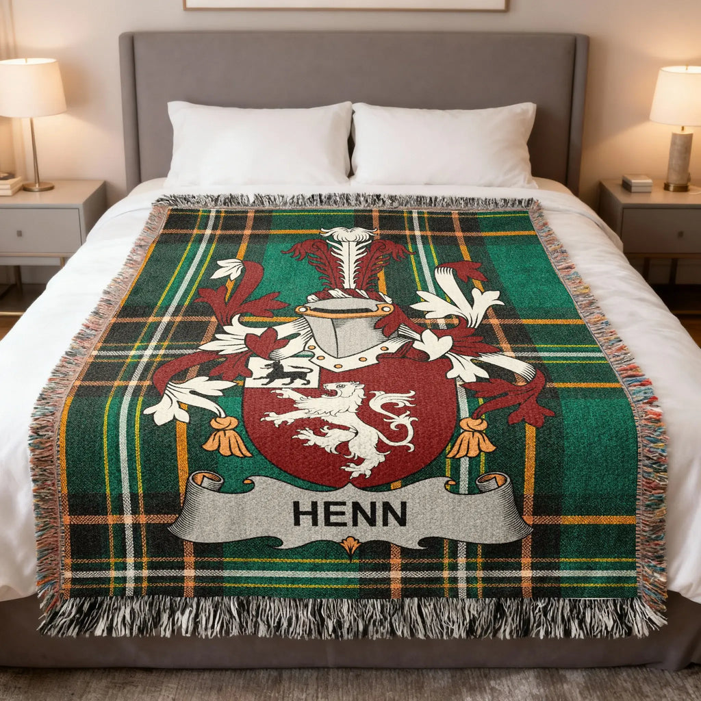 Tartan blanket with Henn family crest on a bed.