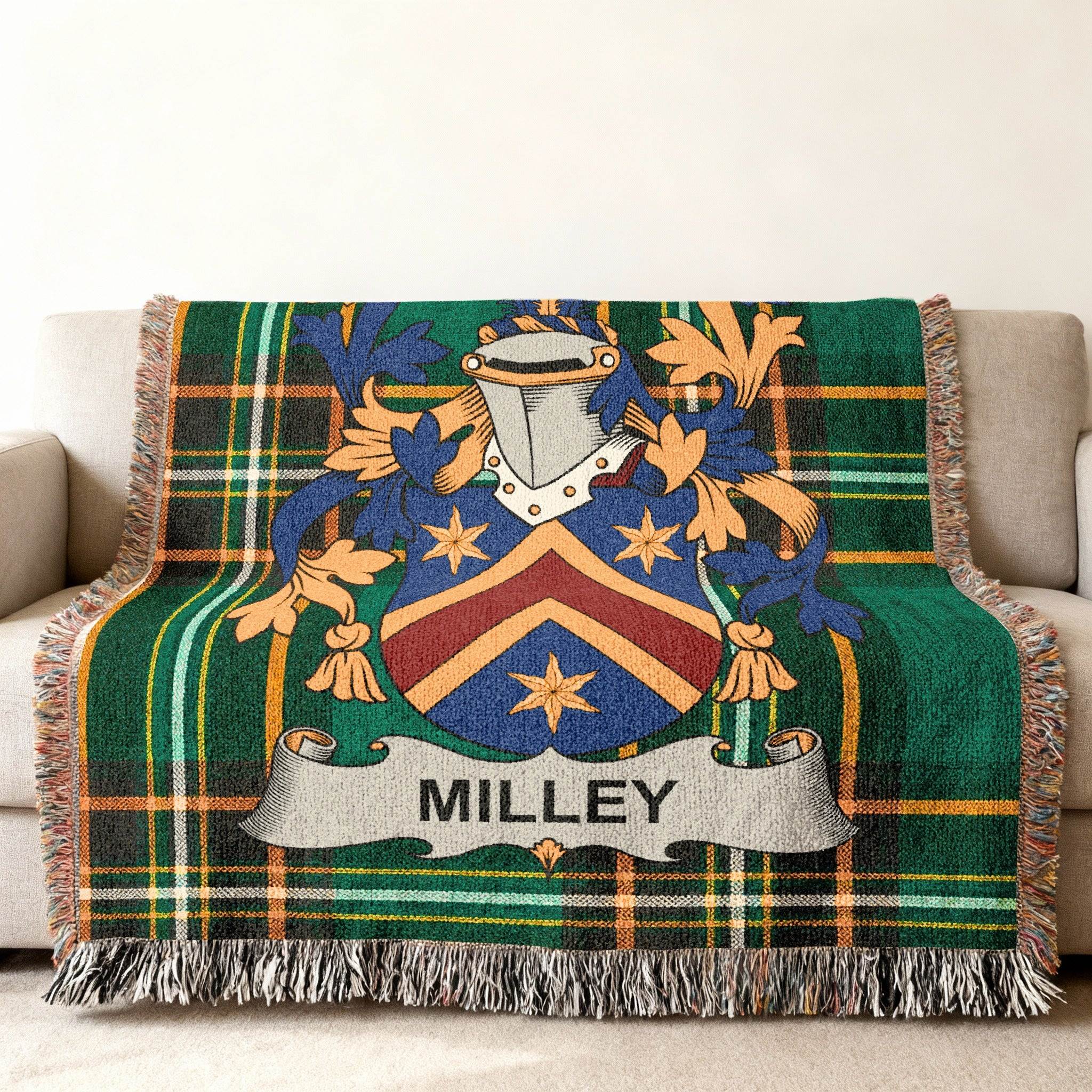 Green tartan throw blanket with Milley family crest in center.