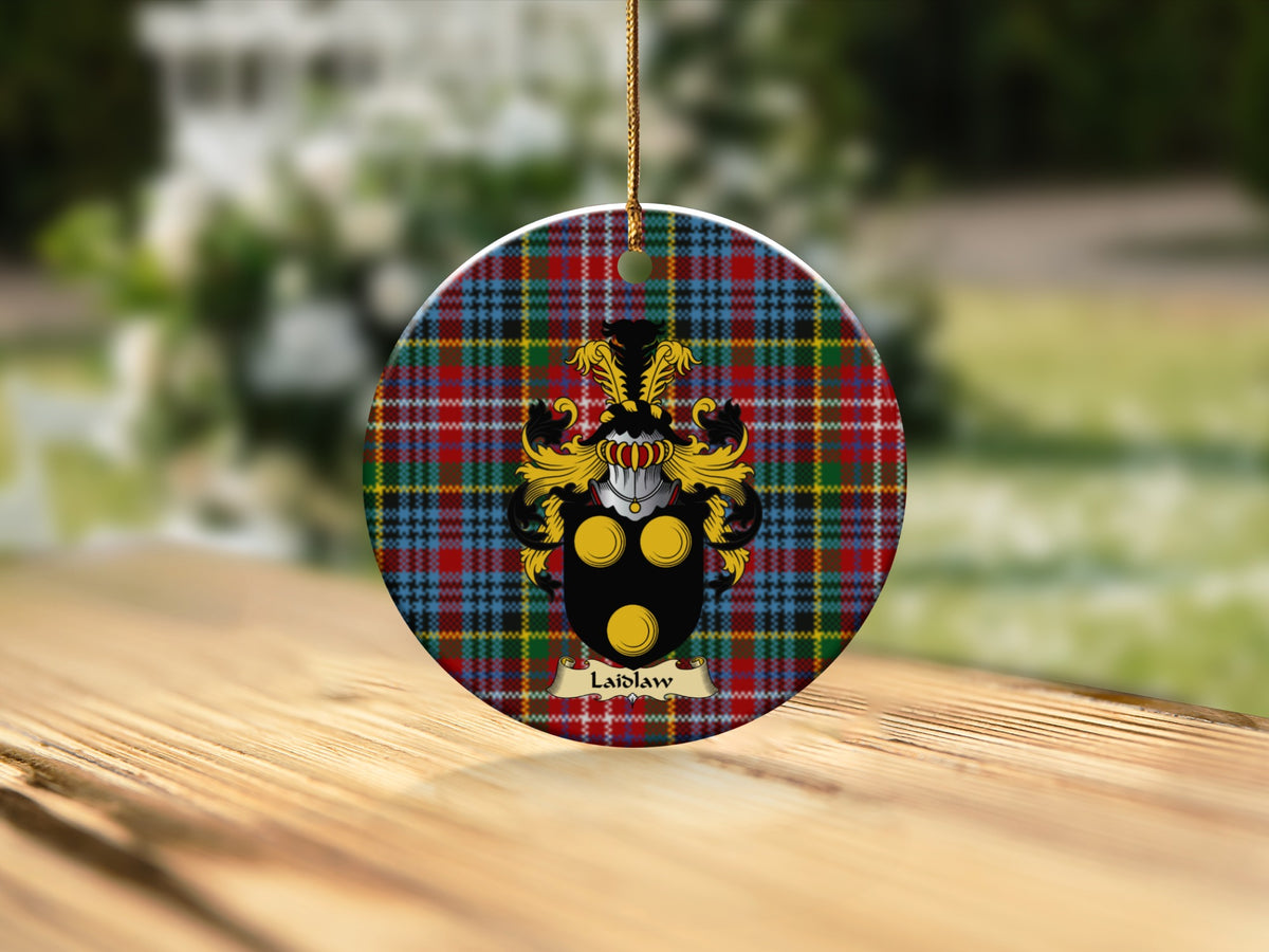 Round Laidlaw Scottish clan ornament with family crest on a Caledonia tartan background