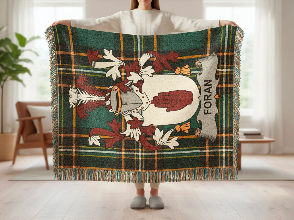 Tartan blanket with Foran clan crest featuring a hand and helmet.