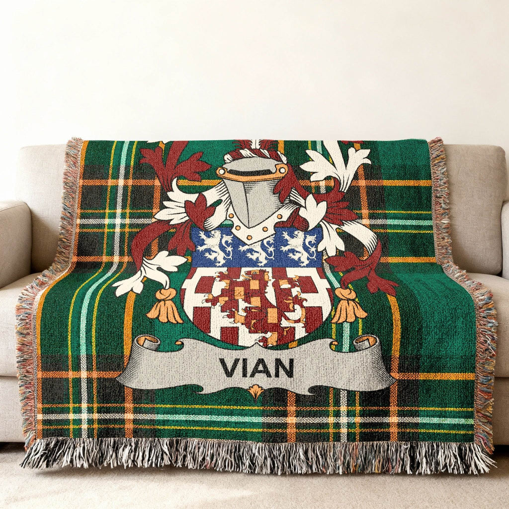 Green tartan blanket with Vian family crest draped over a sofa.