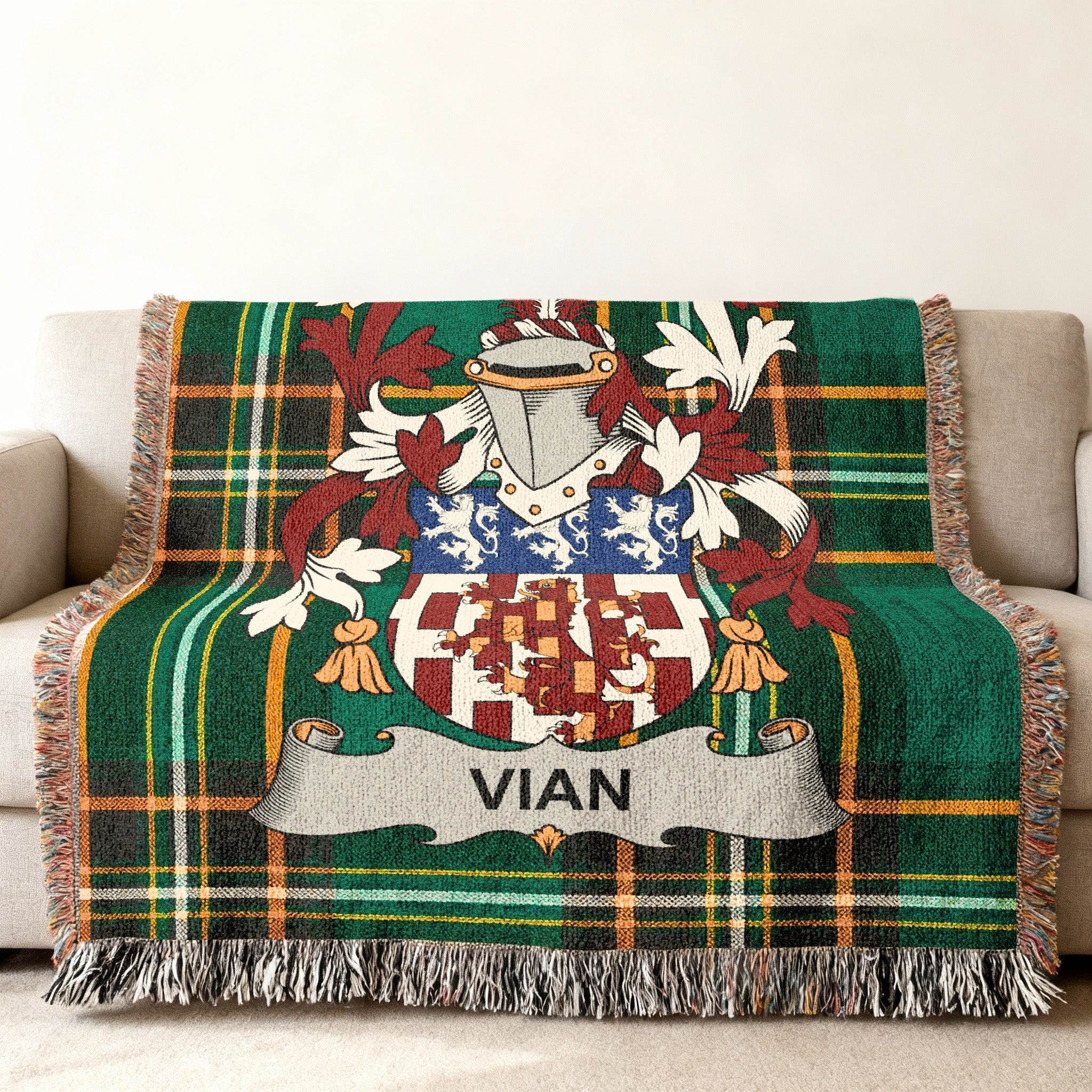Green tartan blanket with Vian family crest draped over a sofa.