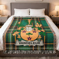 Green plaid throw blanket with the Vandeleur coat of arms.