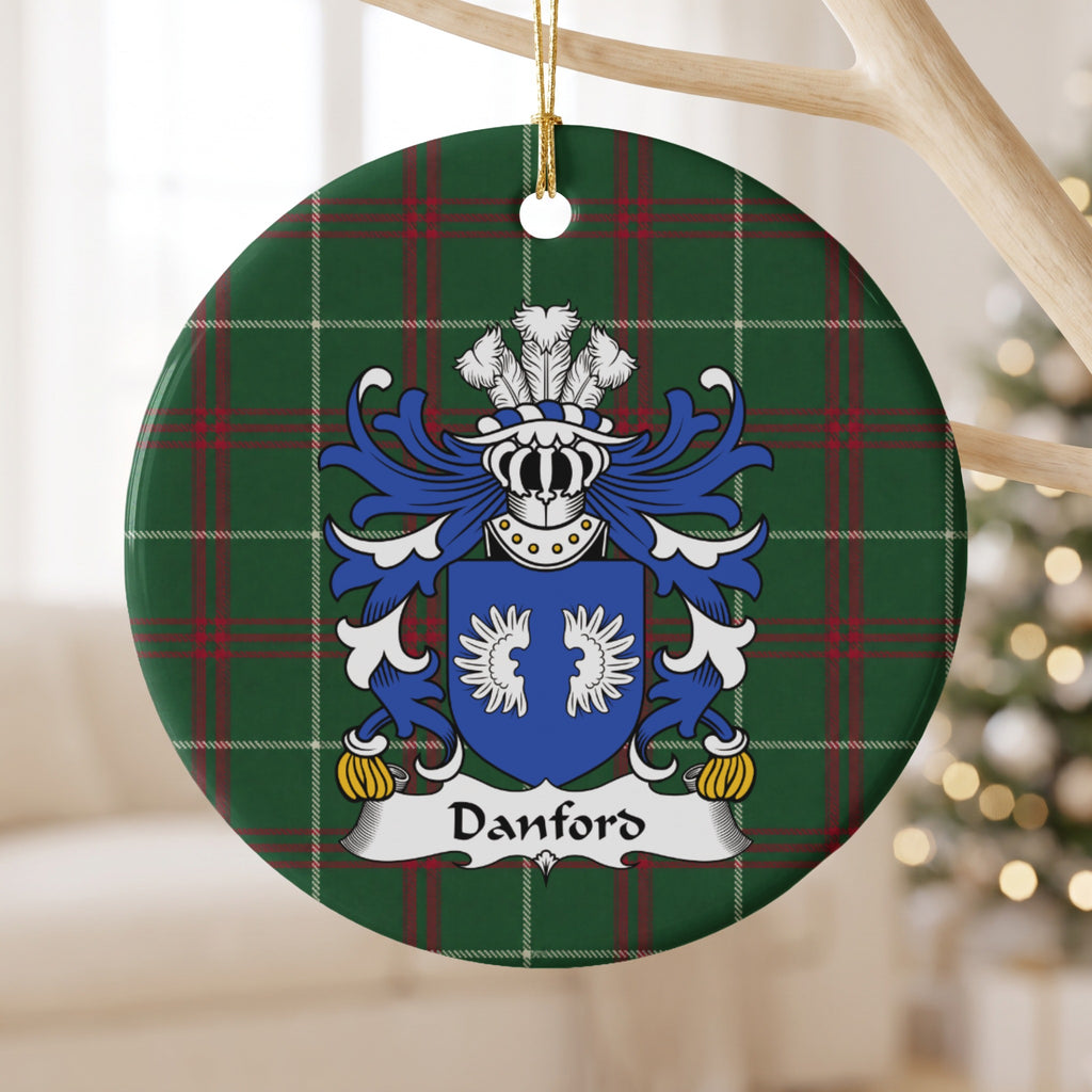 Danford ornament hanging from a pale wooden branch; two white wings on a blue shield on Welsh national tartan.