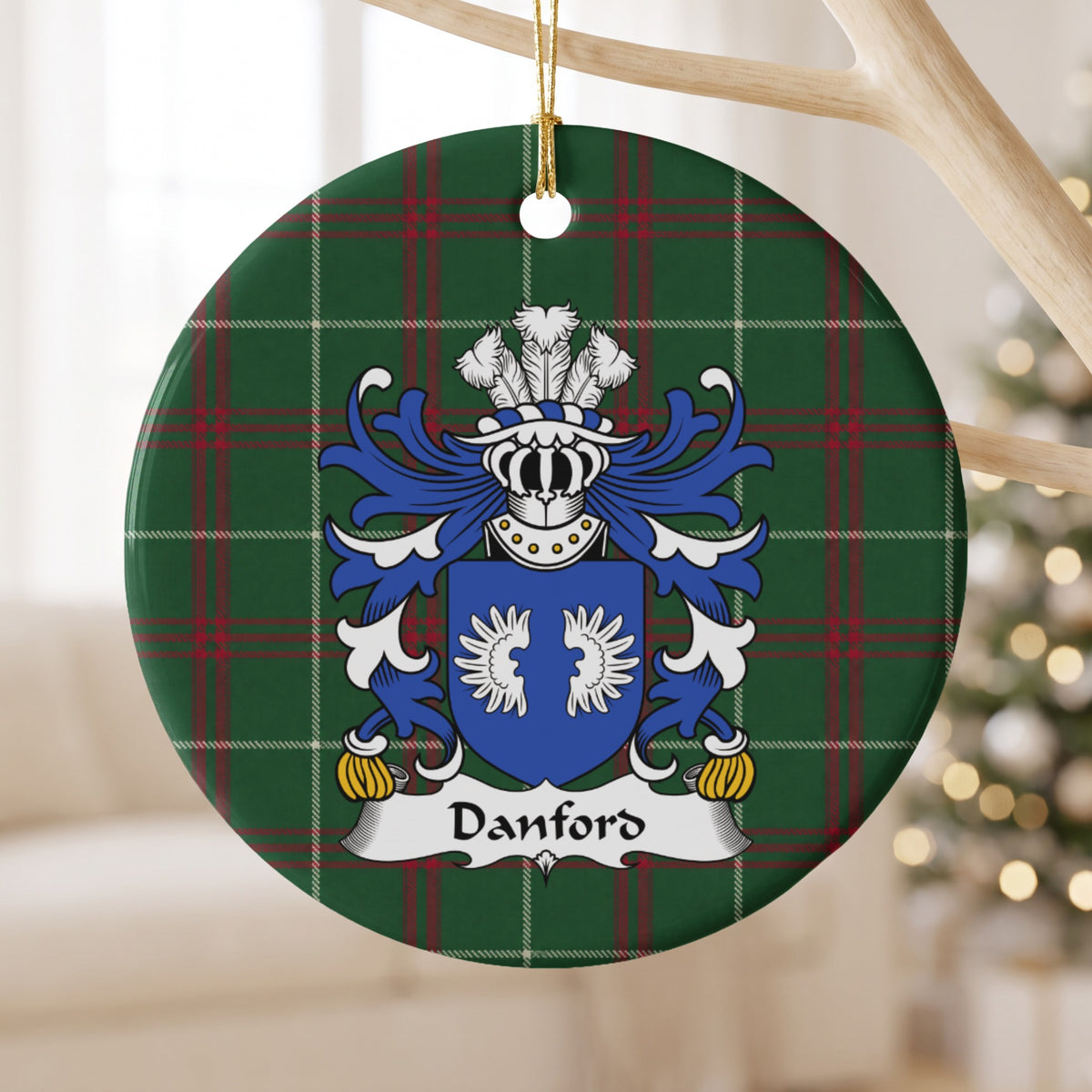 Danford ornament hanging from a pale wooden branch; two white wings on a blue shield on Welsh national tartan.