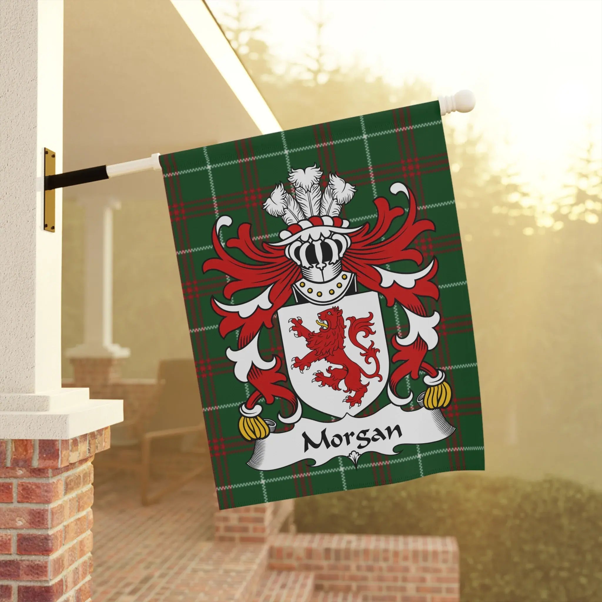 Morgan family crest on a green tartan flag, displayed outdoors.