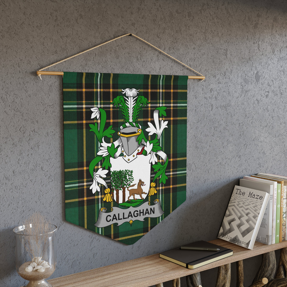 Callaghan coat of arms banner on green tartan fabric displayed on a wall.