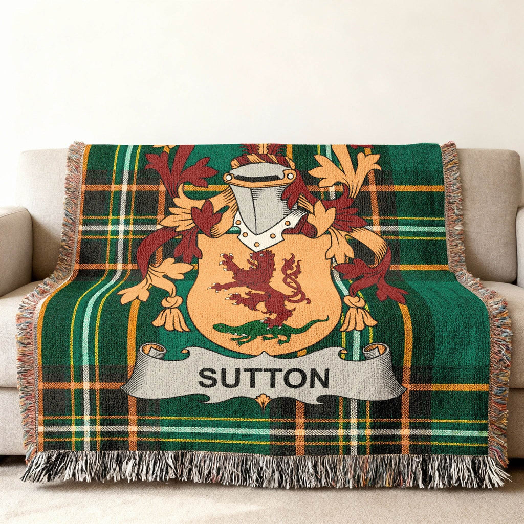 Green plaid throw blanket with a coat of arms featuring a lion and the name "Sutton".