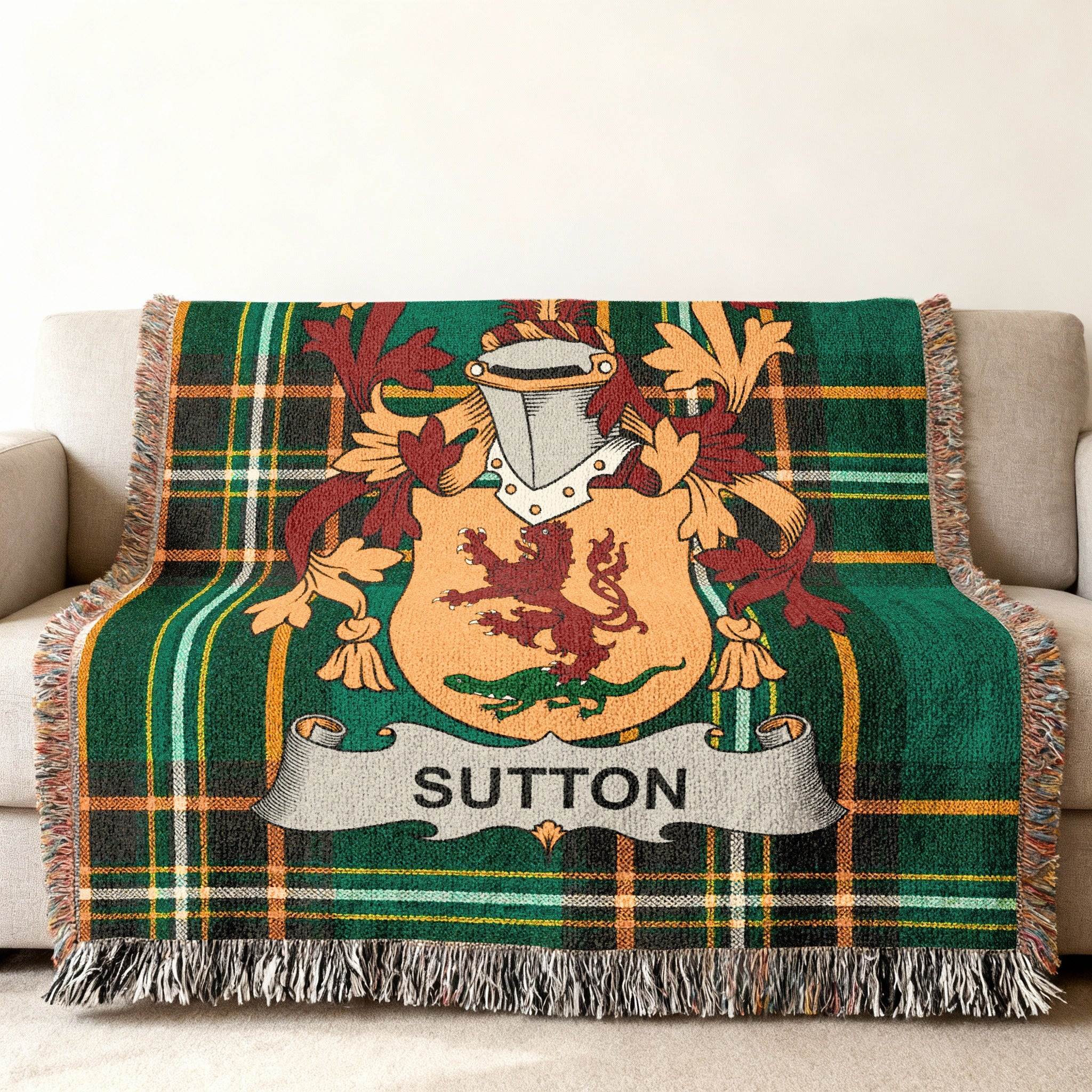 Green plaid throw blanket with a coat of arms featuring a lion and the name "Sutton".