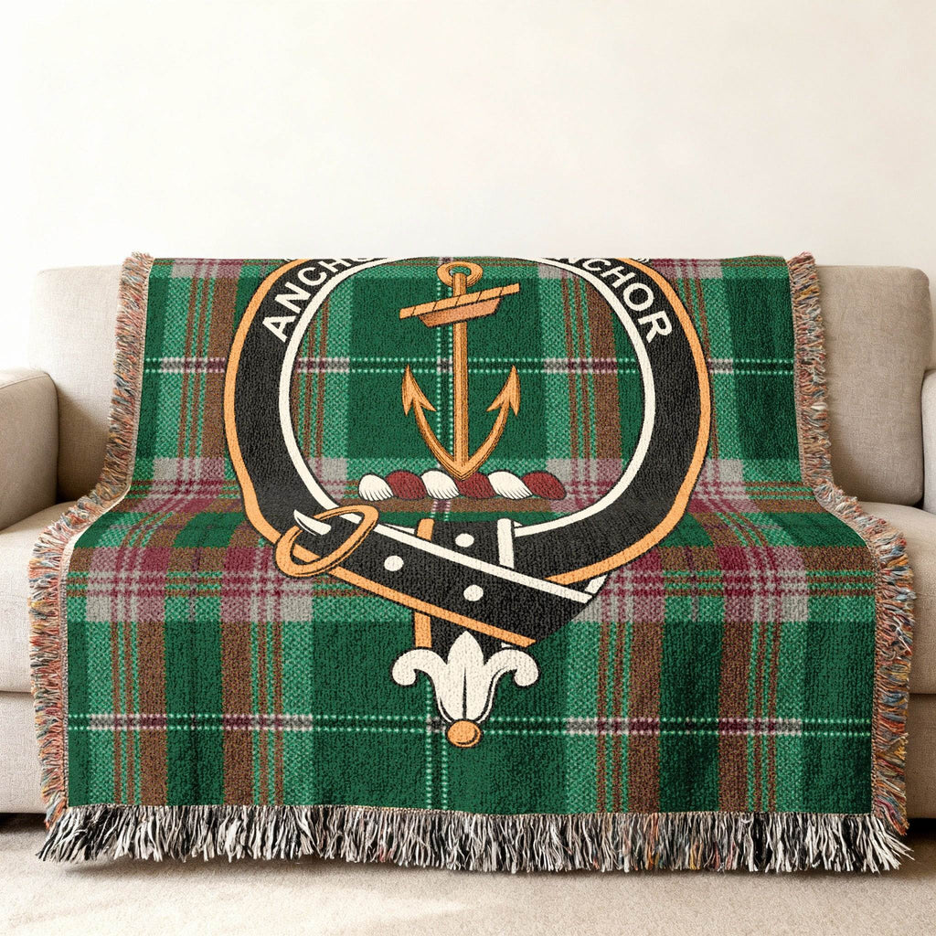 Gray clan crest tartan woven blanket — green plaid anchor design at centre, fringe visible