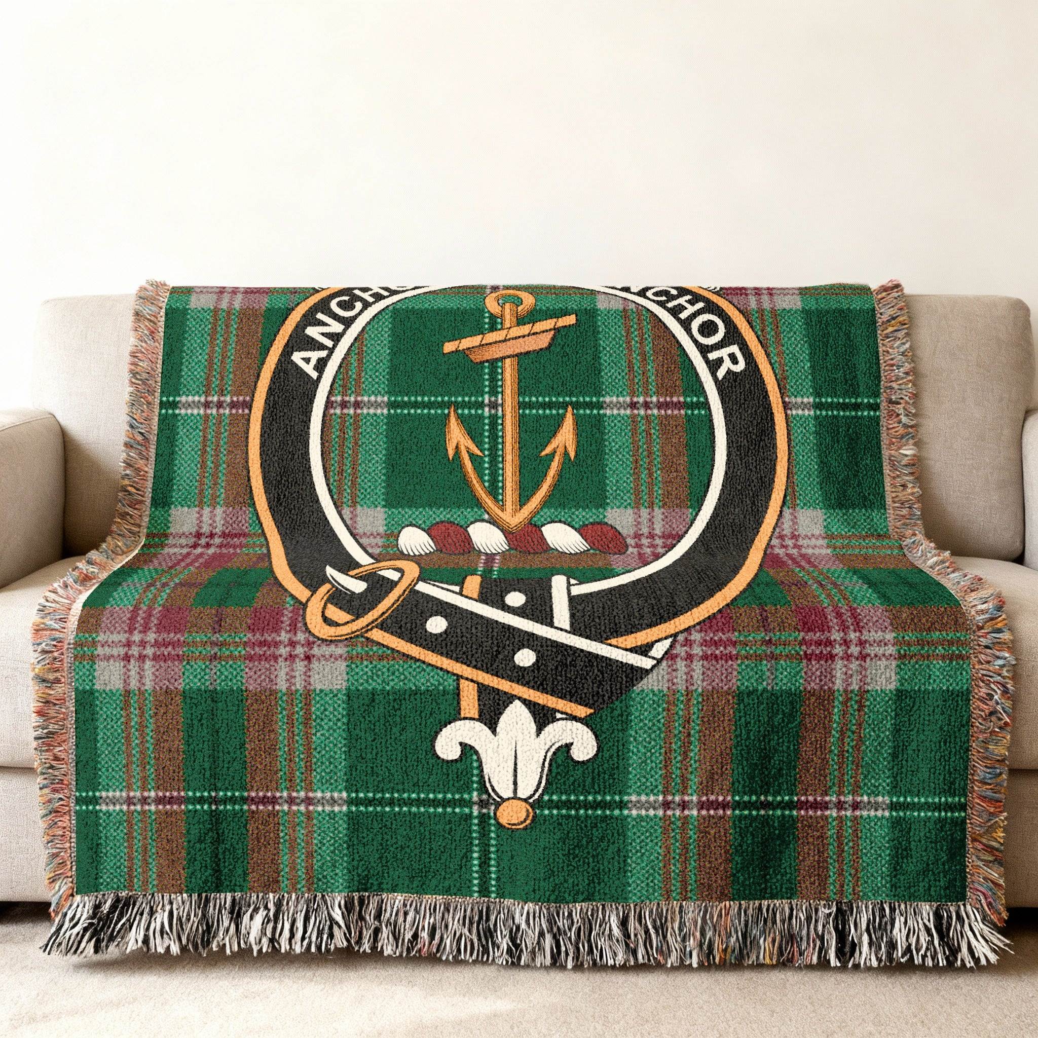 Gray clan crest tartan woven blanket — green plaid anchor design at centre, fringe visible