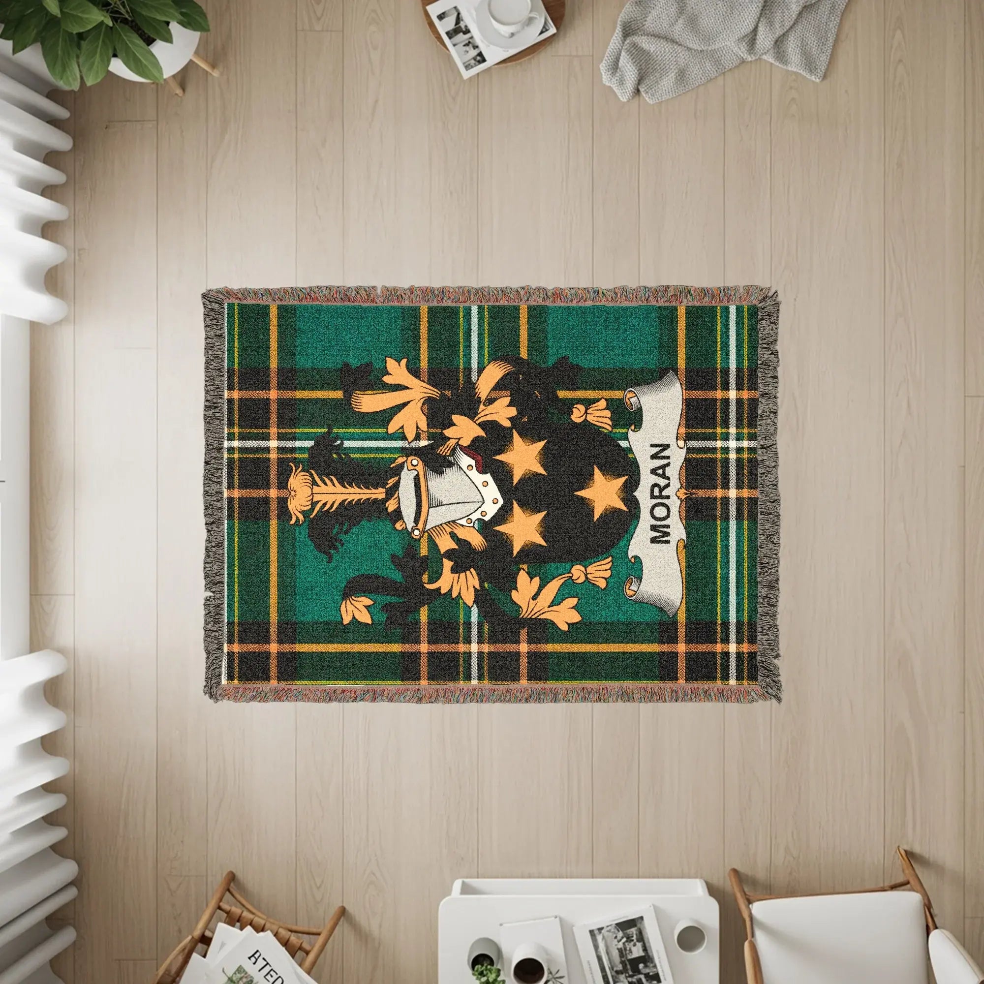 Moran tartan blanket with a crest and fringe, viewed from above.