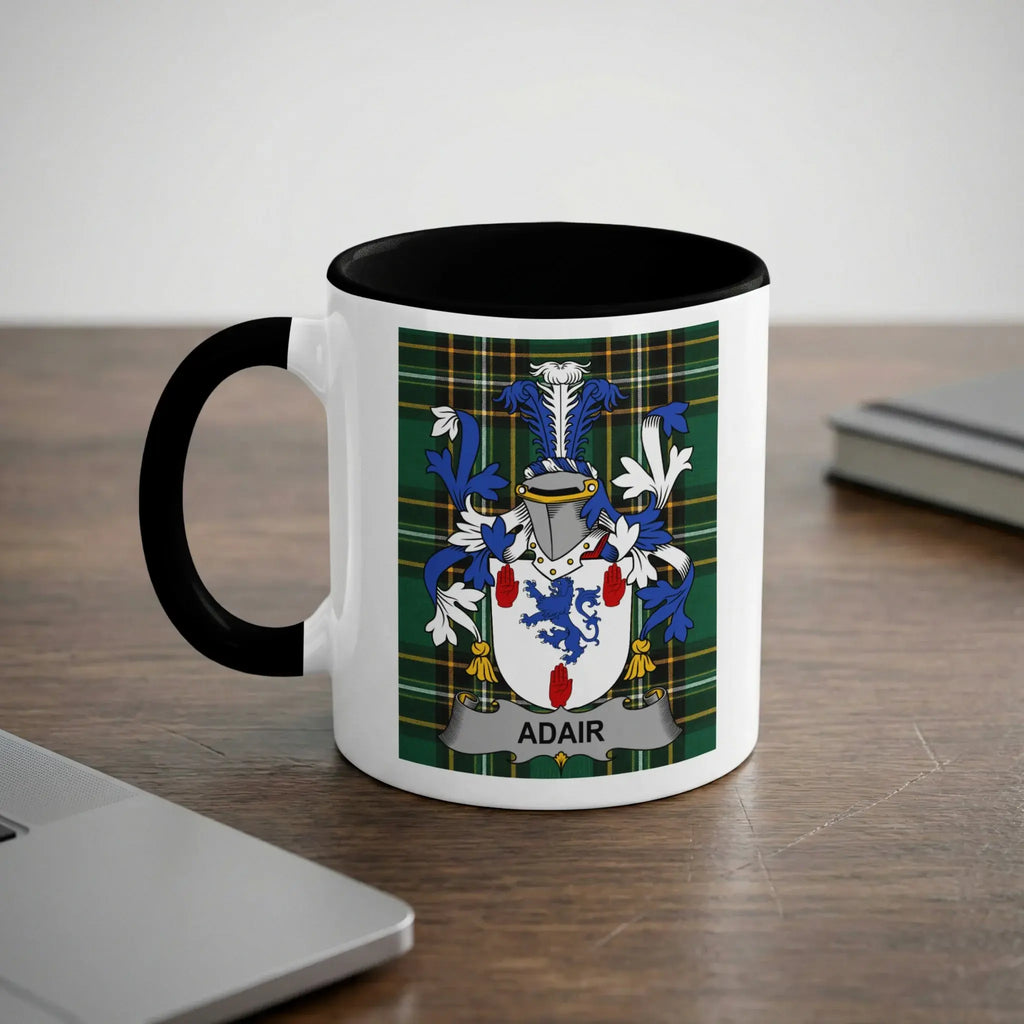 White mug with black rim, featuring Adair family crest on a plaid background.
