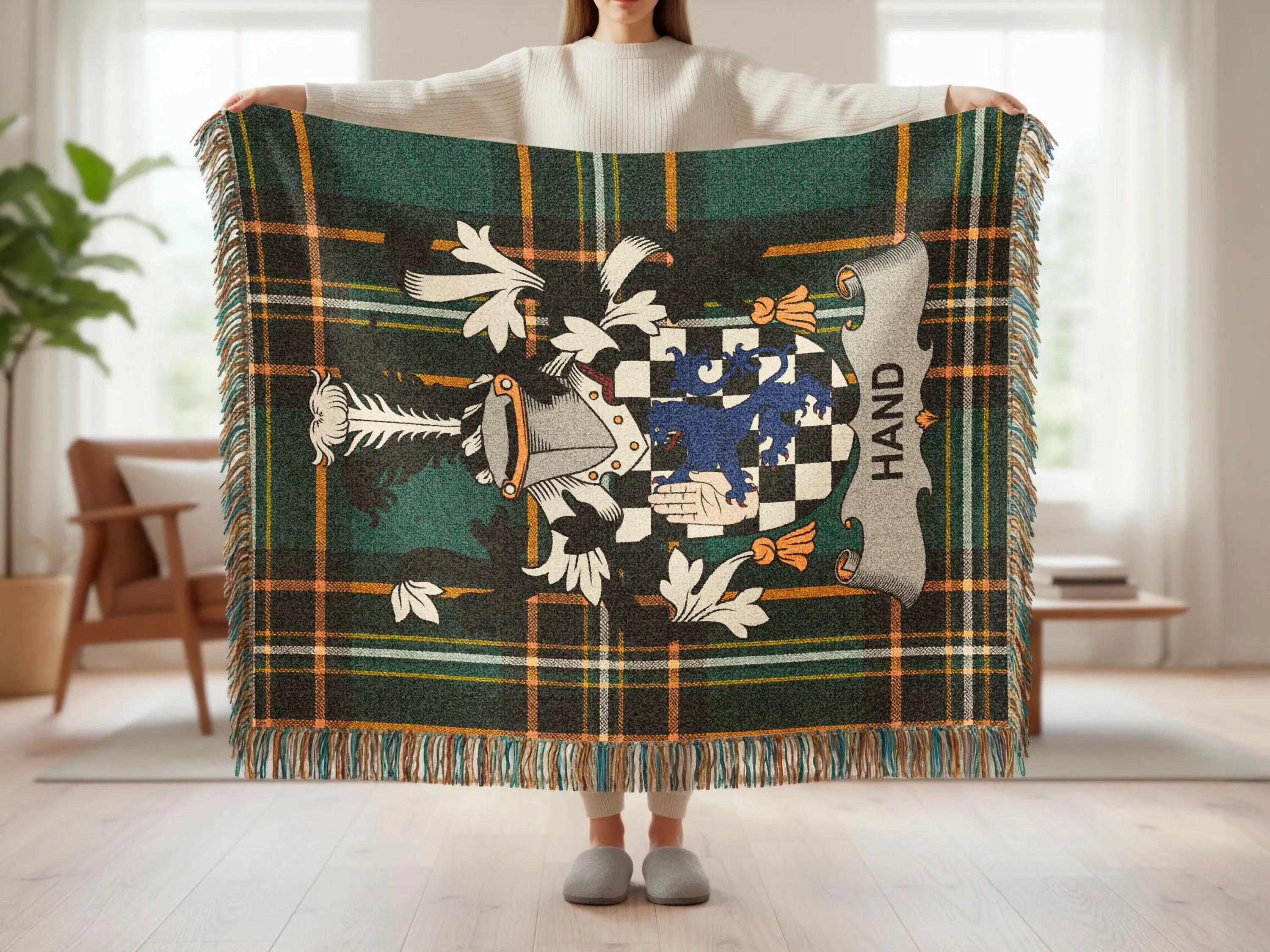 Green plaid tartan blanket with a family crest featuring a lion and shield.