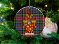 Leitch Scottish clan ceramic ornament with family crest on a Caledonia tartan background, hanging on a Christmas tree