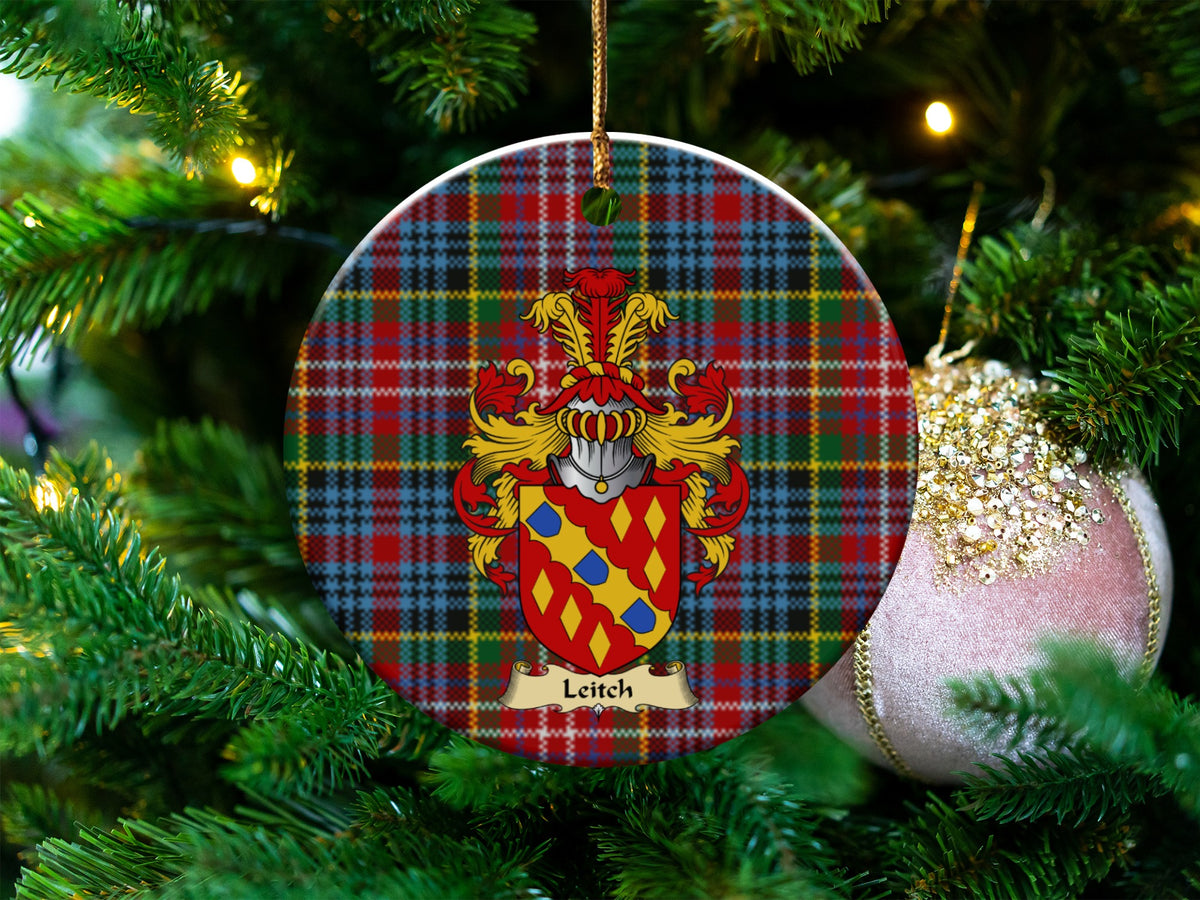 Leitch Scottish clan ceramic ornament with family crest on a Caledonia tartan background, hanging on a Christmas tree