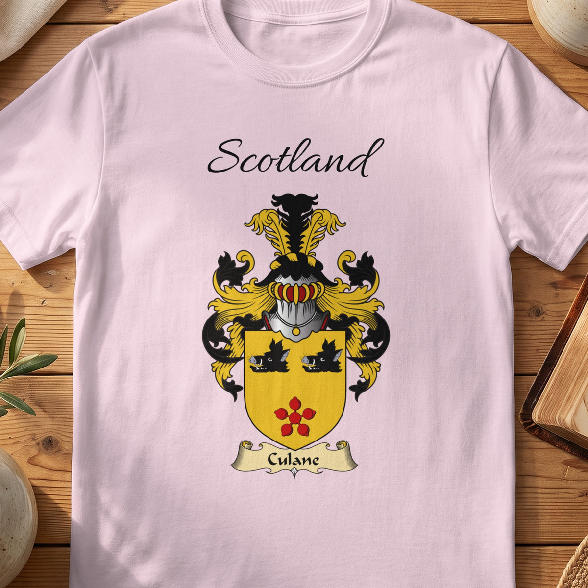 Light Pink Culane Scottish family shield T-shirt featuring two black boar heads above a red flower