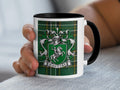 Maguire Irish family crest mug with black accents and Irish National Tartan, lifestyle view