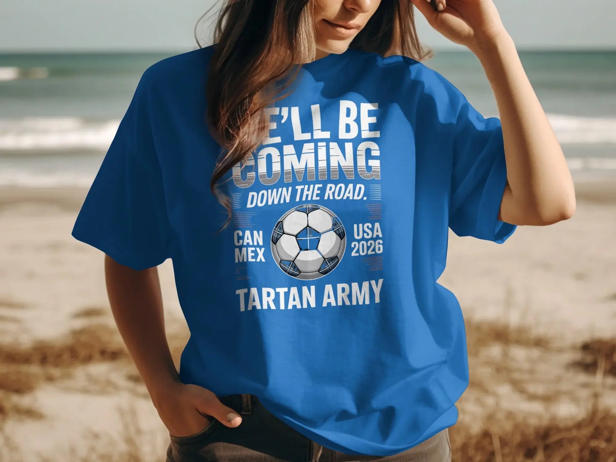 Blue t-shirt with "WE'LL BE COMING DOWN THE ROAD" and "TARTAN ARMY" text.