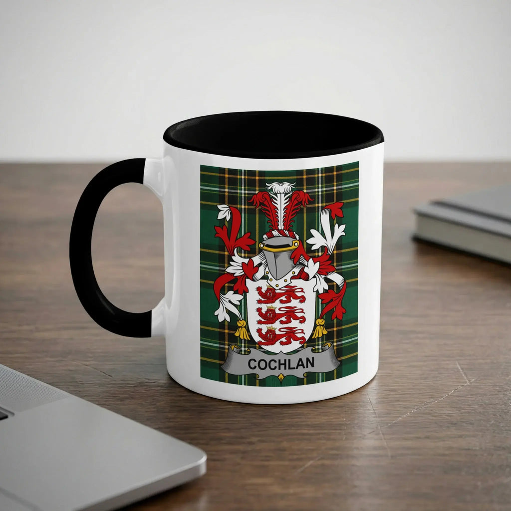 White mug with black handle featuring the Cochran family crest on a tartan background.