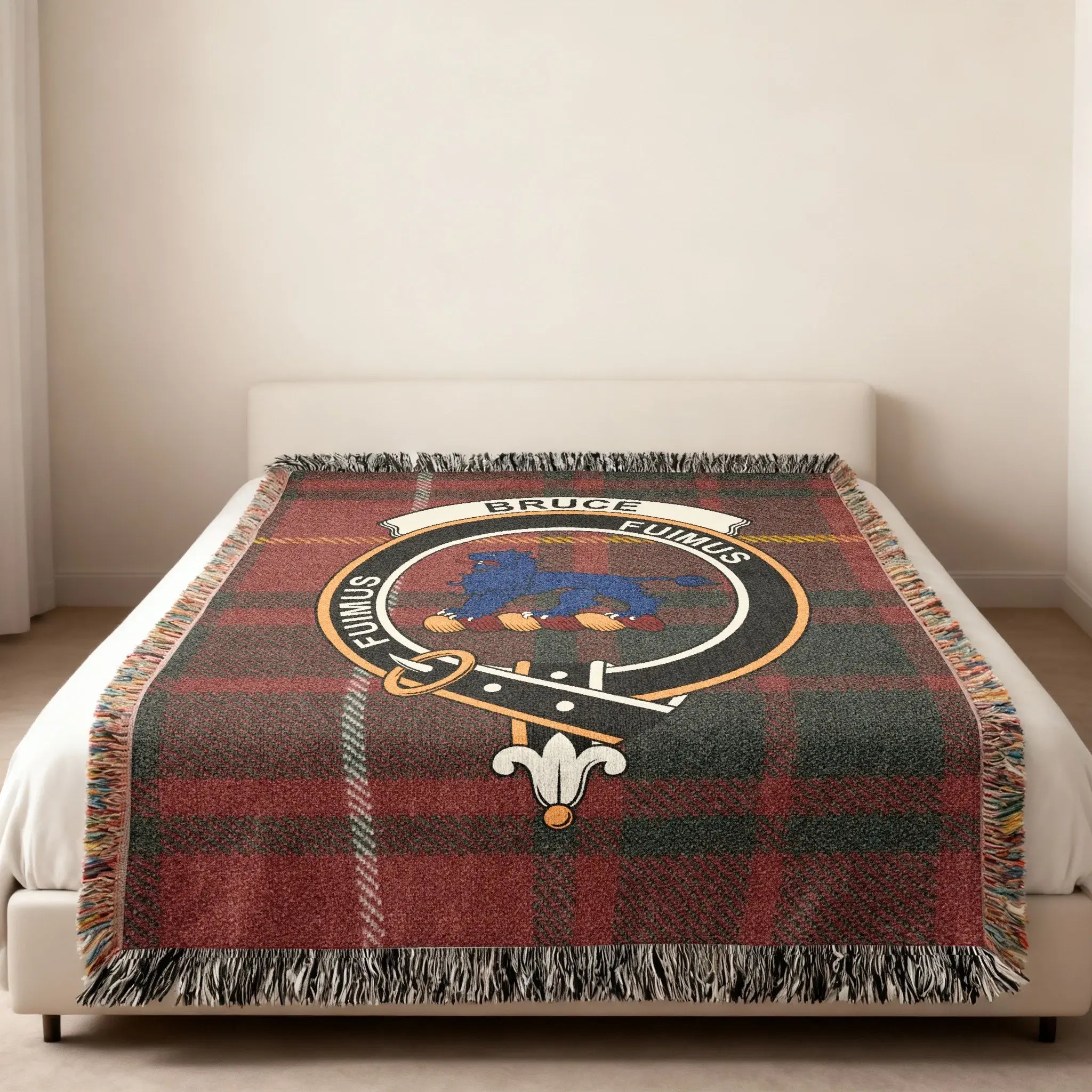 Bruce tartan woven blanket in room setting — clan crest at centre, fringe edge visible