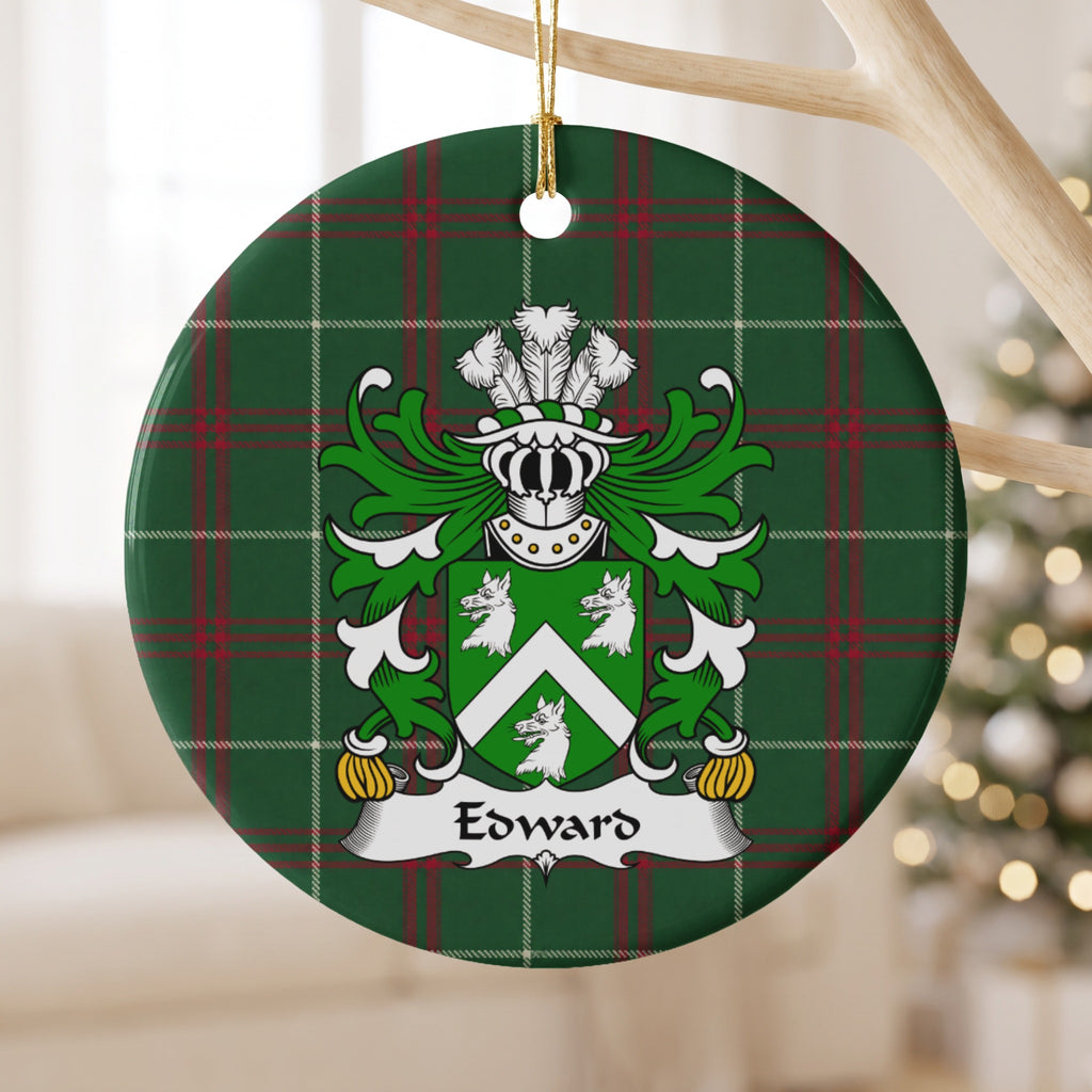 Edward Style 2 ornament hanging from a pale wooden branch; a white chevron between three white wolf heads on a green shield on Welsh national tartan.