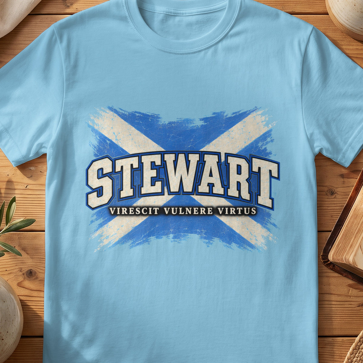 Stewart Scottish Saltire T-shirt in Sky, with distressed blue and cream flag and “Virescit Vulnere Virtus” lettering.