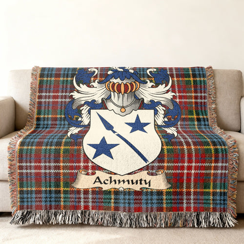 Achmuty Scottish family shield woven blanket with Caledonia tartan background on a sofa