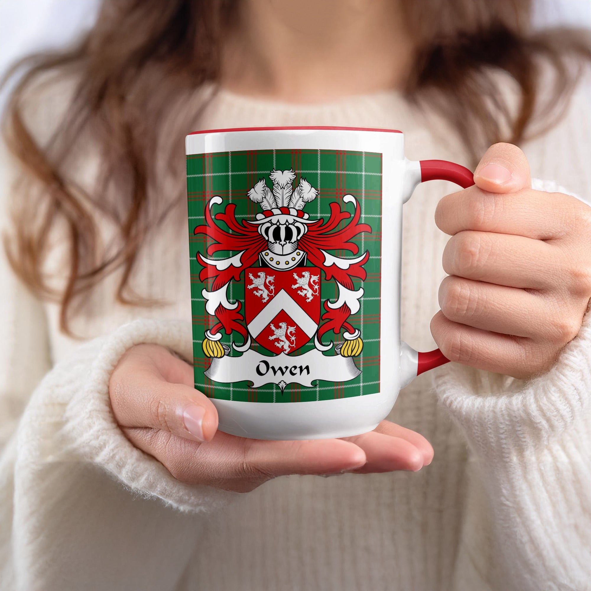 Owen Welsh family name mug with red accent and coat of arms held in hand on tartan