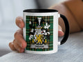 White mug with black handle displaying the Trevor family crest on a tartan background.