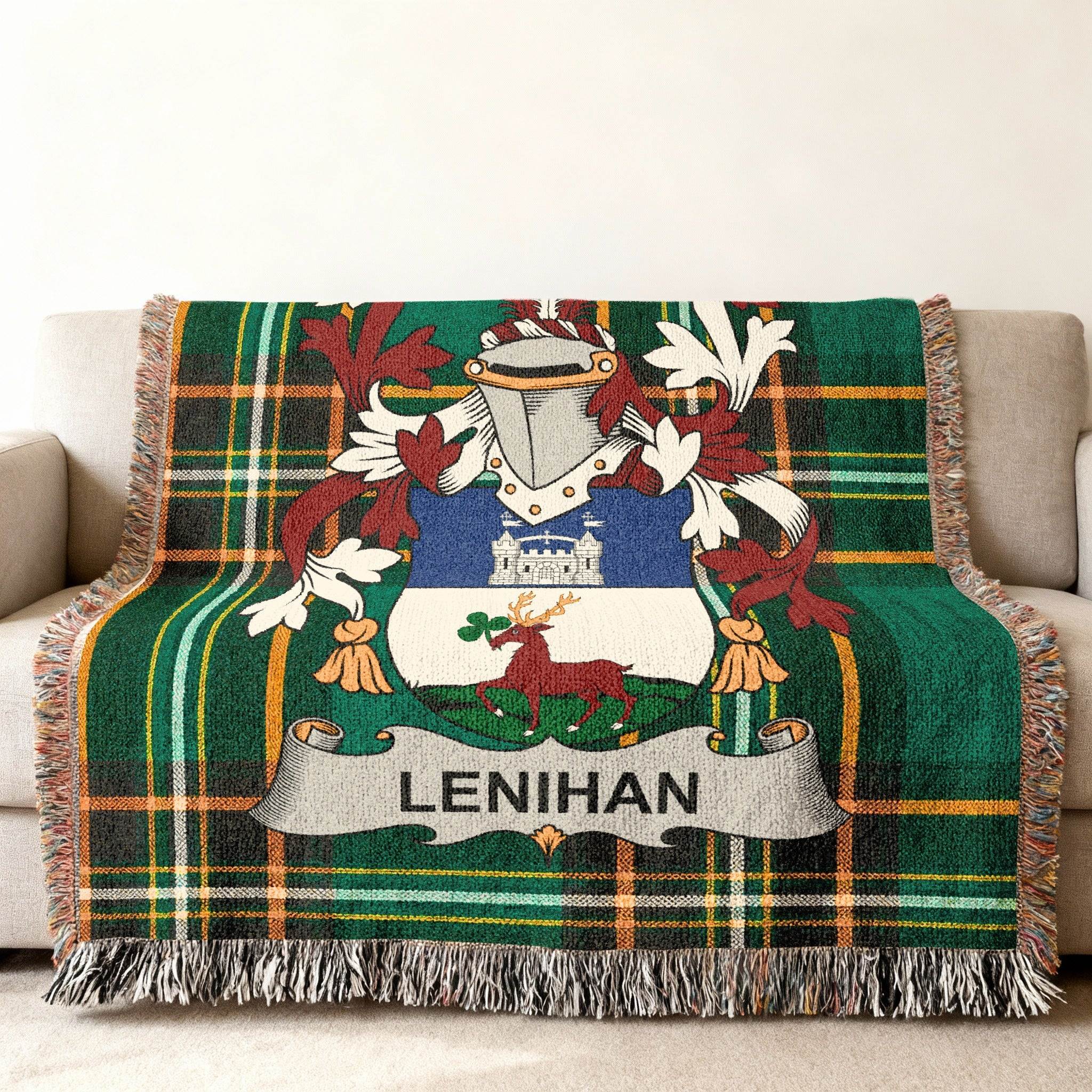 Green tartan throw blanket featuring the Lenihan family crest on a couch.