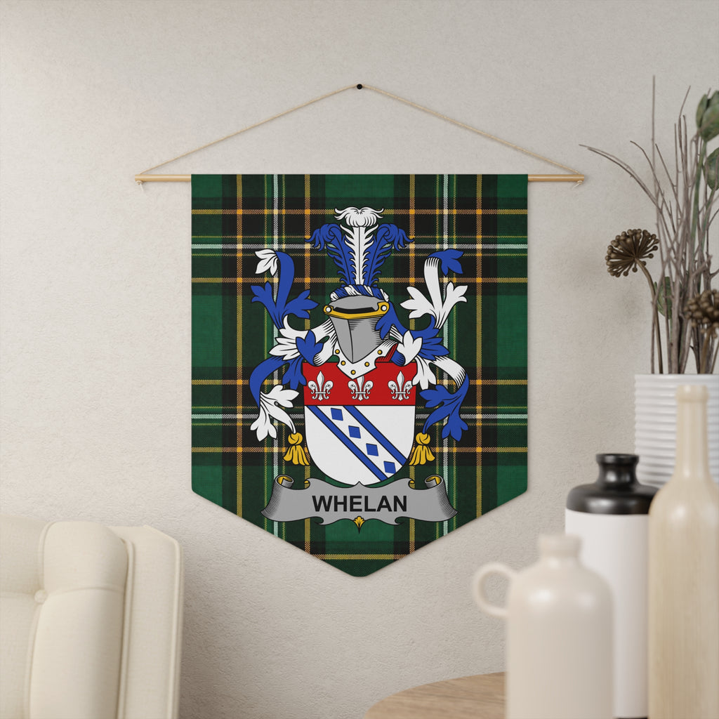 Whelan family crest on a green tartan pennant banner hanging on a wall.