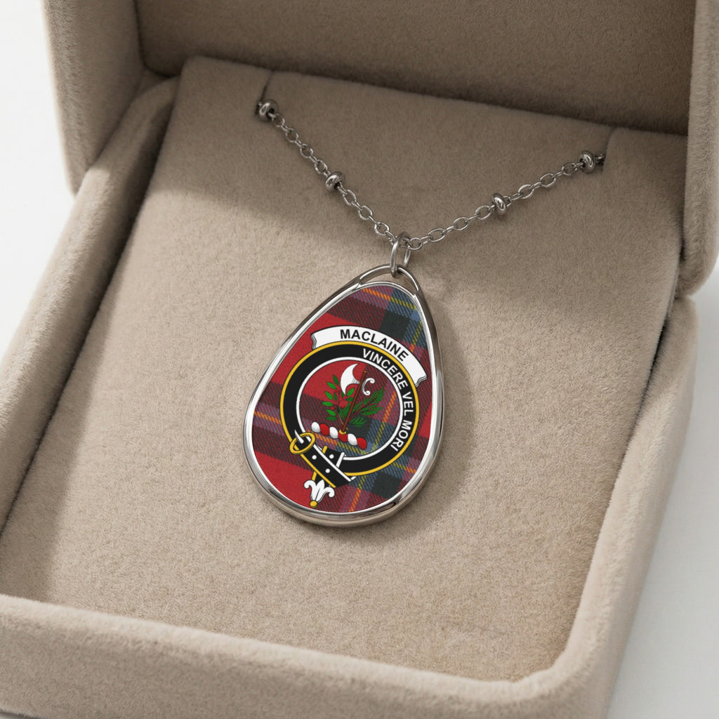 Maclaine oval pendant necklace with clan crest on tartan, displayed in a neutral box.
