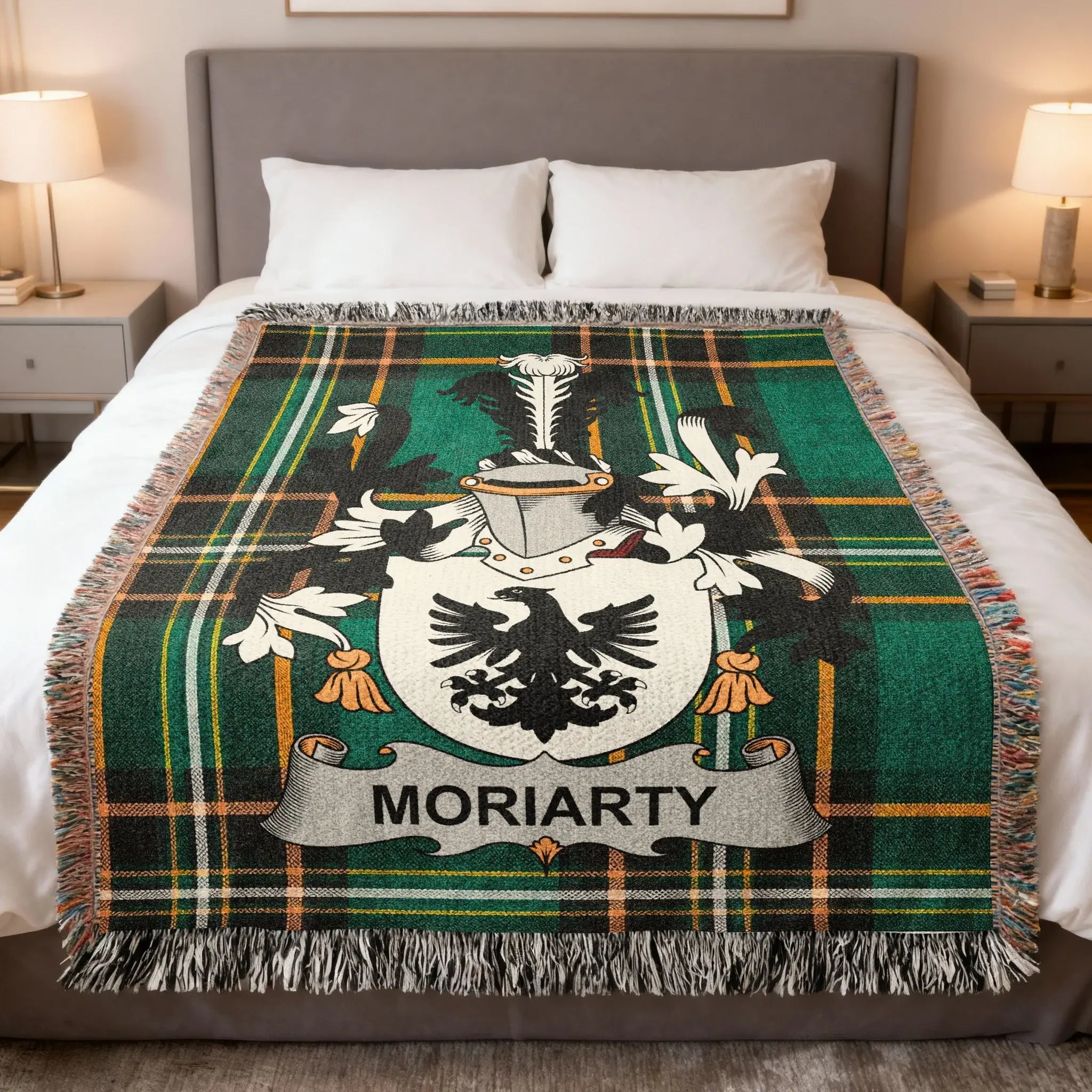 Moriarty family crest on a green plaid woven blanket on a bed.