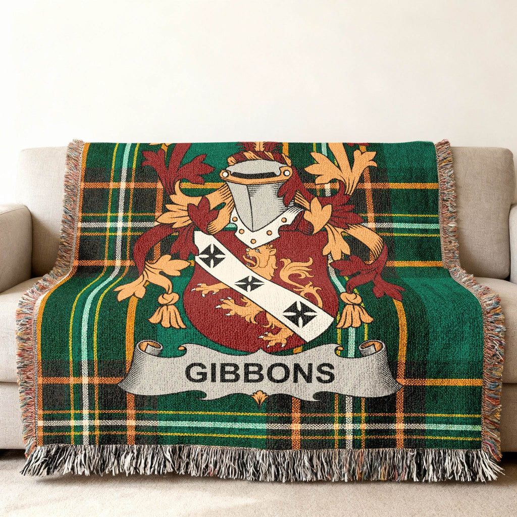 Gibbons family crest on a green tartan wool blanket with fringe.