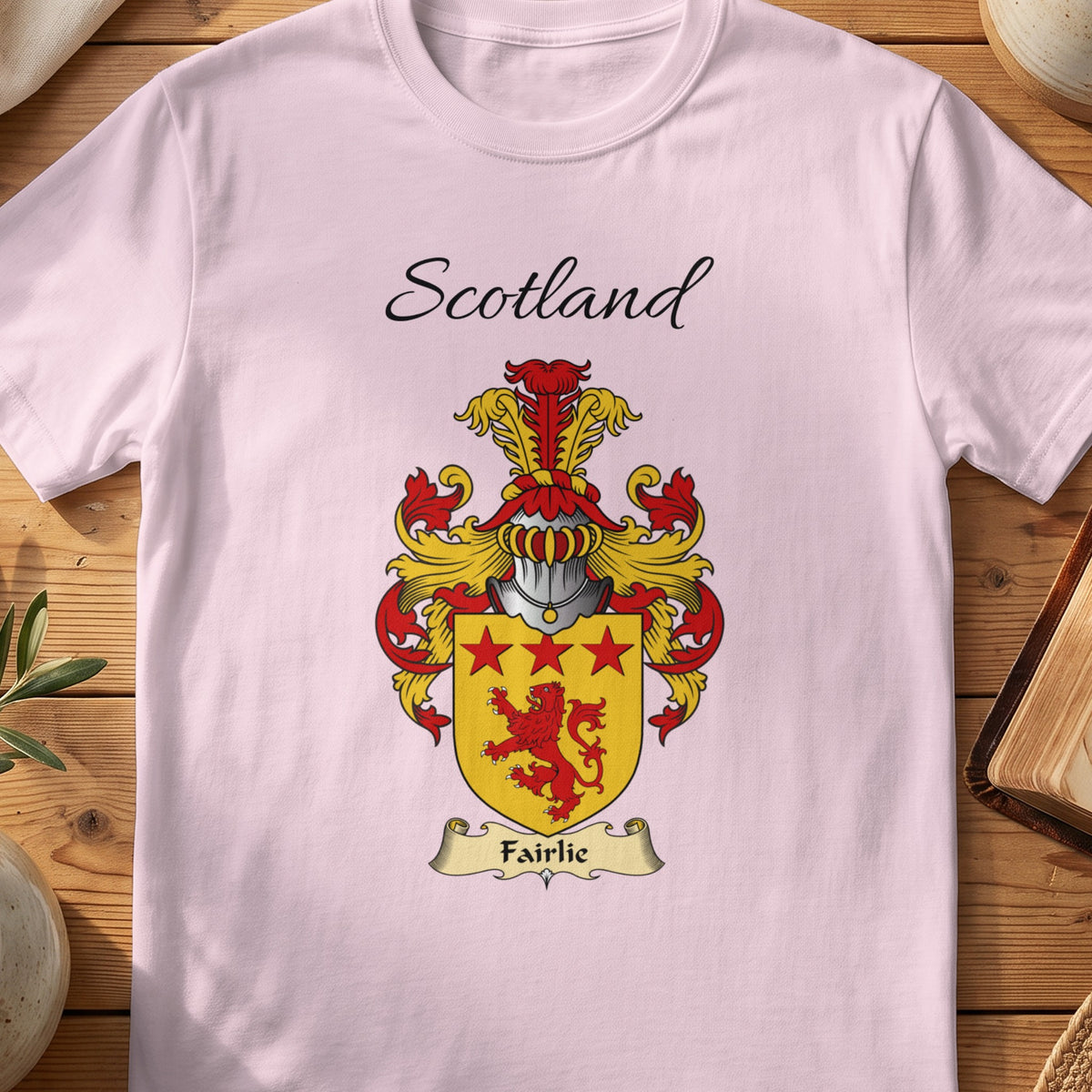 Light Pink Fairlie Scottish family shield T-shirt featuring a red lion and red stars on gold