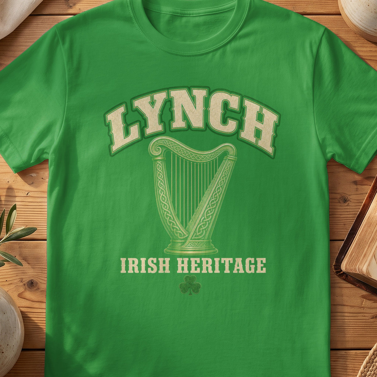 Lynch Irish harp T-shirt in Irish Green, with cream surname lettering, a gold-toned harp, green shamrock and “Irish Heritage” text.