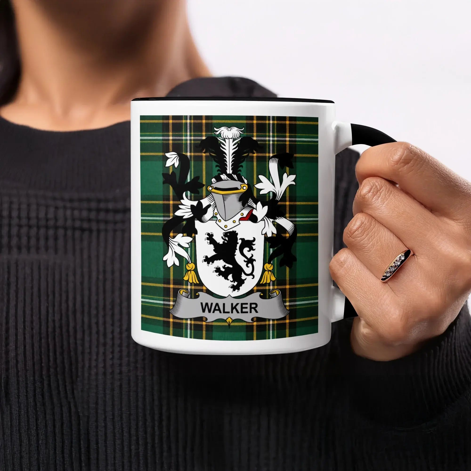 Walker family crest on a black and white mug held by a person.